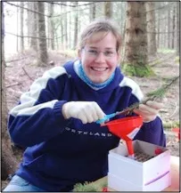 Laura Junker taking samples from a tree seedling