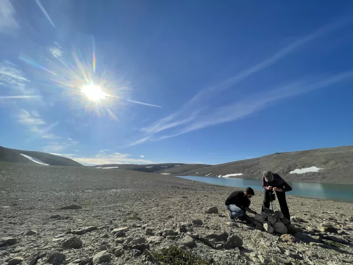 Researchers work outdors in High Arctic field research location on a sunny day