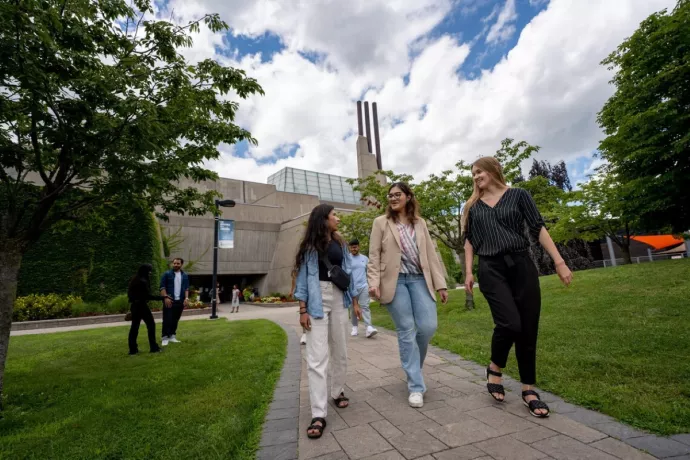 women walk on a campus path