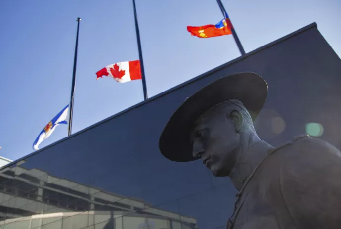 Flags of Nova Scotia and Canada fly at half-staff outside the Nova Scotia Royal Canadian Mounted Police (RCMP) headquarters in Dartmouth, Nova Scotia, Canada, on April 19, 2020