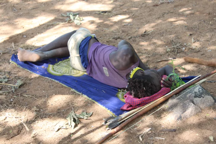Hadza man sleeping on ground