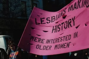pink banner with black text that reads Lesbians Making History