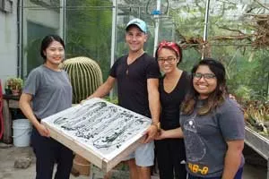 Research team members Kyungwon Ha, Peter Schnurr, Corina Ramirez and Radia Tasnim display a tray of harvested spirulina 