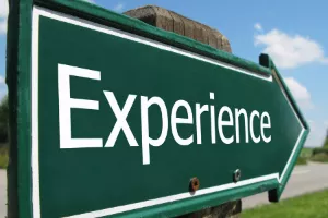 Green directional arrow with the word "Experience" in white letters
