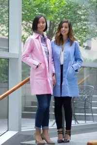 Two women wearing pink and light blue Modadoro lab coats