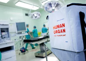 hospital operating room and white organ donation box with red lettering