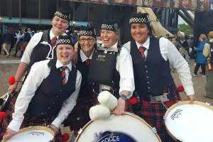 group of women in Scottish dress with drums