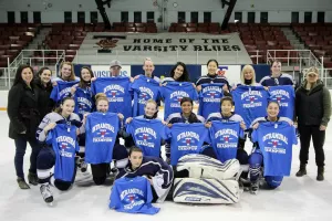 UTM Egles women's ice hockey team holding championship shirts