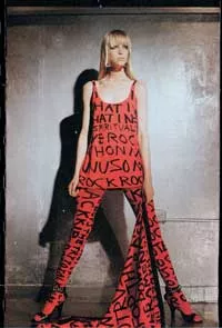 Model Teri Toye wears a red suit covered in black graffiti. Photo by Steven Sprouse, courtesy of Toye.