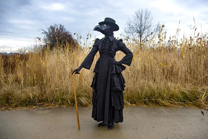 Madeleine Mant wearing the plague doctor black ruffle dress and black bird-like mask