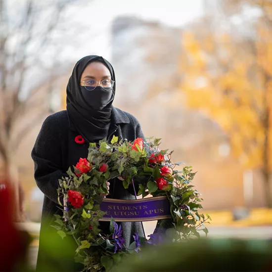 Woman laying Remembrance Day wreath