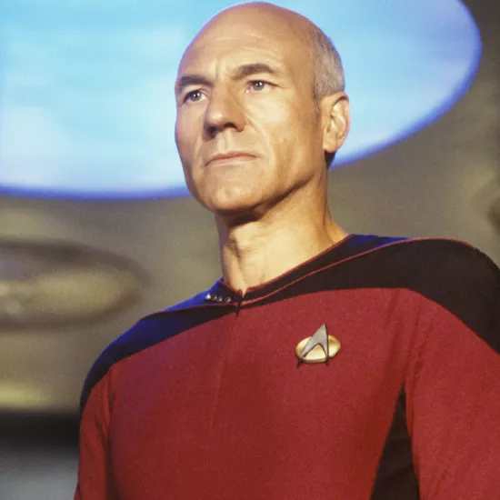 Star Trek's Jean-Luc Picard stands on the transporter pad