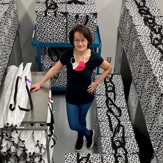 Lisa Cheung standing in a room surrounded by black and white boxes