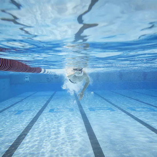 Underwater photo of a male swimming laps in a pool