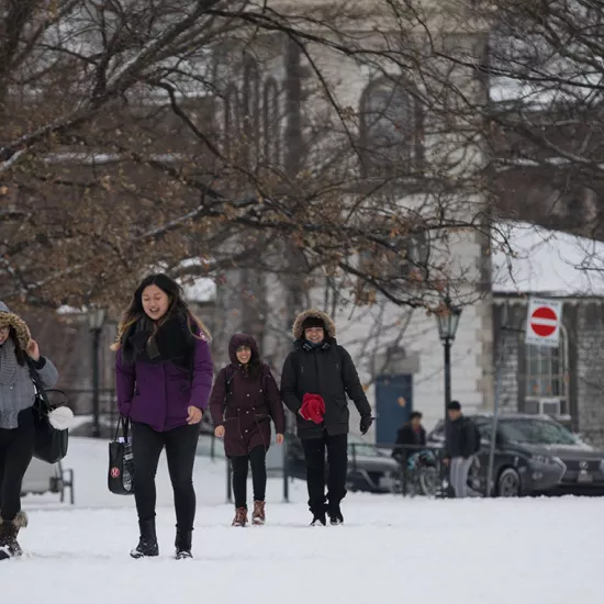 Photograph of students walking through a snowy campus