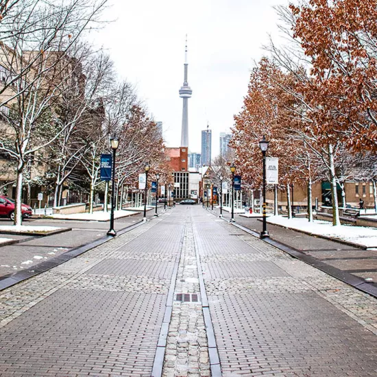 Image of CN Tower at end of cobble-stone street on a snowy day