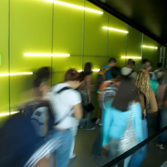 students walking by green wall at CCT