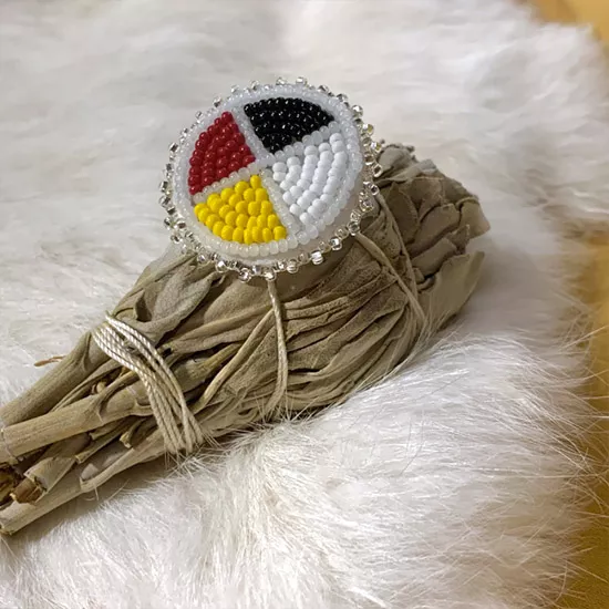 Beaded Indigenous medicine wheel on a bundle of white sage