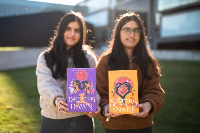 Sarena and Sahsa holding copies of their books from the Ria and Rani Series
