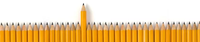 Row of pencils with one higher than the others