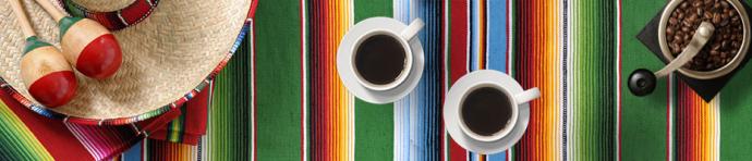 Sombrero and coffee on a colourful Mexican tablecloth