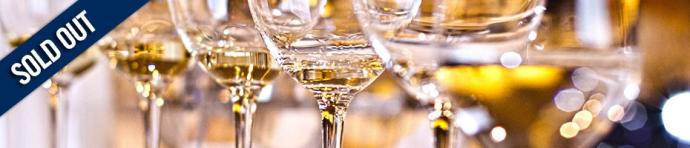 Close up of multiple glasses of white wine 