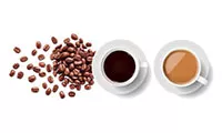 Two cups of coffee on a white table with coffee beans