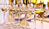 Close up of wine glasses filled with white wine