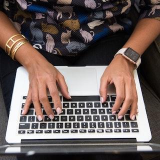Image of person's hands typing on laptop