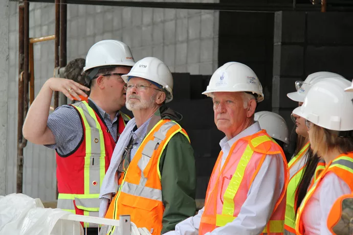 Paul Donoghue guiding building and planning on campus with a construction team