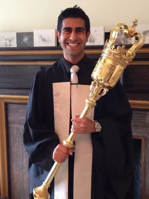 Aly Madhavji holding the convocation mace