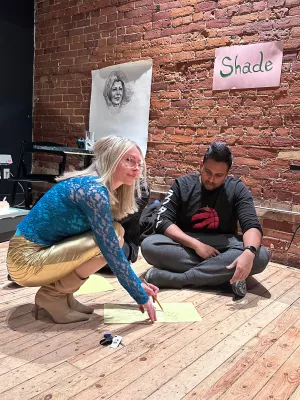 Erin Finley sketching with a student at a Drawing Disco session