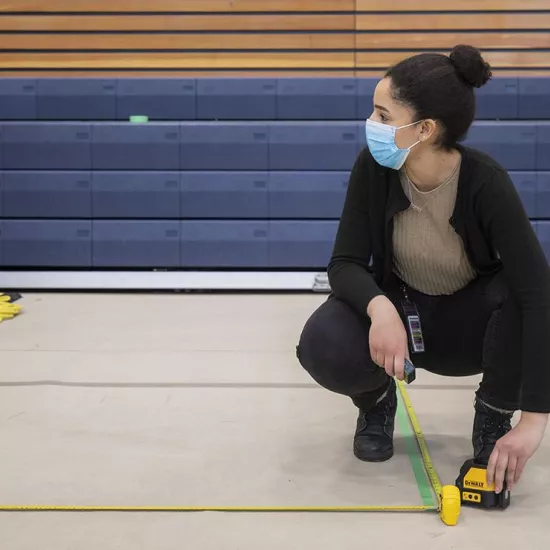 UTM alumna Reem El-Ajou helping set up vaccination lines at RAWC
