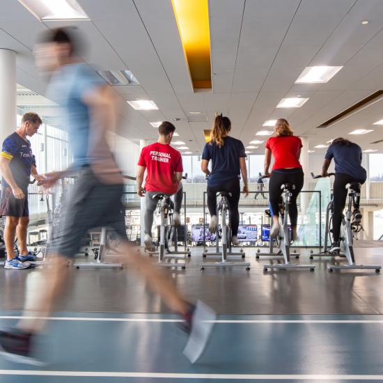 Track level of Fitness Centre with a group on elliptical bikes