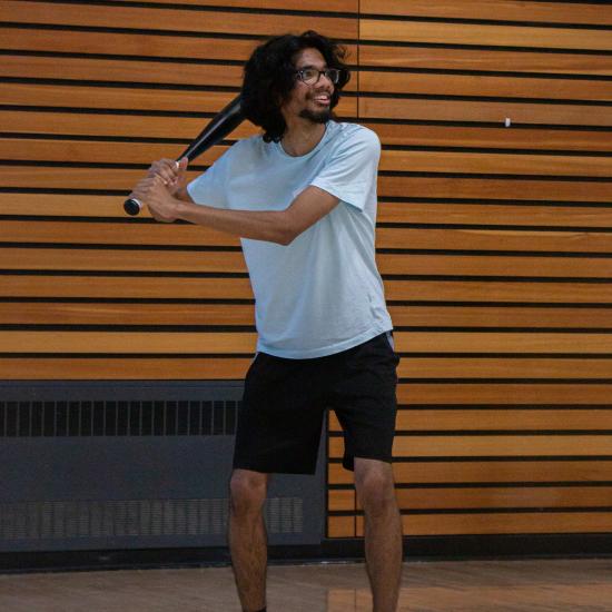 individual holding a baseball bat preparing to swing