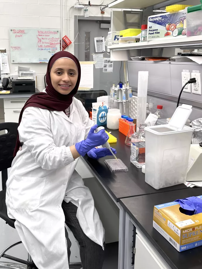 Areej Al Dailami picture, in the lab, wearing a labcoat
