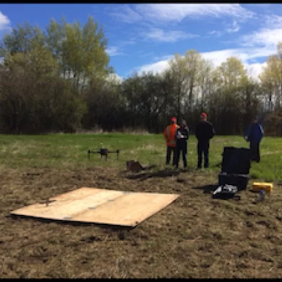 Ensminger lab launching a drone in a field