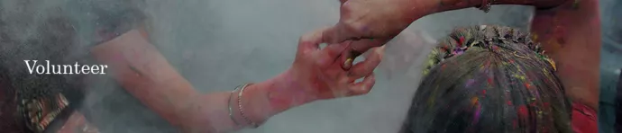 Image of people holding hands during Holi.