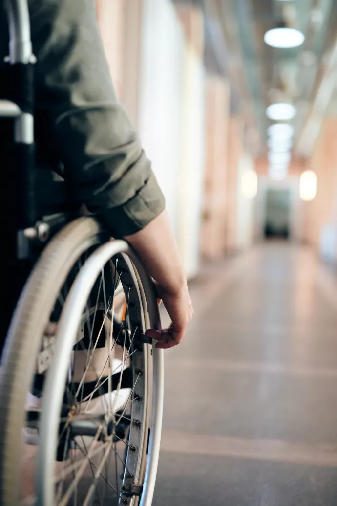 Person in a wheelchair navigating an institutional space
