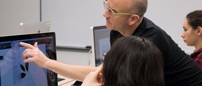 Professor helping students with design at a studio class