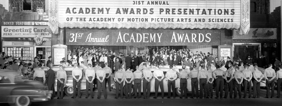 Crowd lining street under the marquee of the Pantages Theater at the 31st Academy Awards in 1959