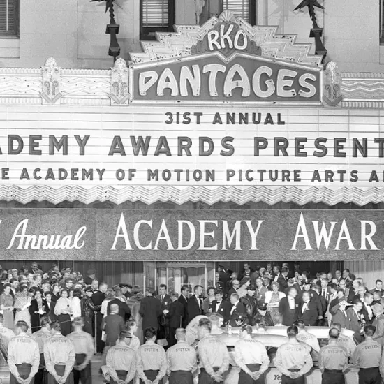 Crowd lining street under the marquee of the Pantages Theater at the 31st Academy Awards in 1959