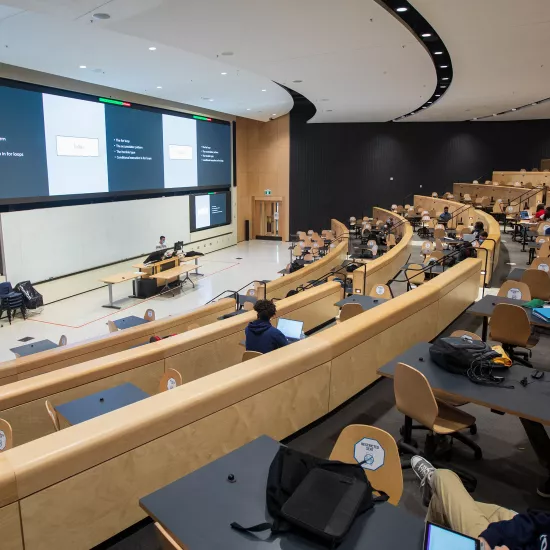 U of T lecture hall with physically distanced students wearing masks