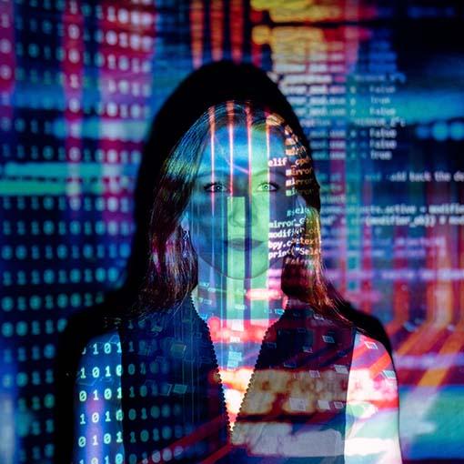 Female software engineer with projected code. Photo by ThisisEngineering RAEng on Unsplash