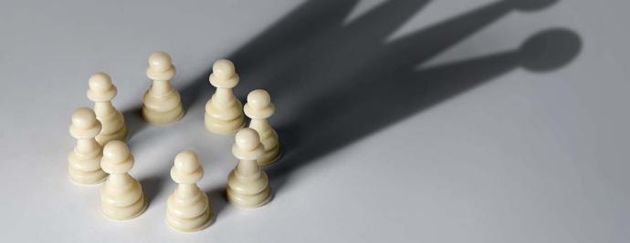 Chess pieces arranged in a circle against a grey background