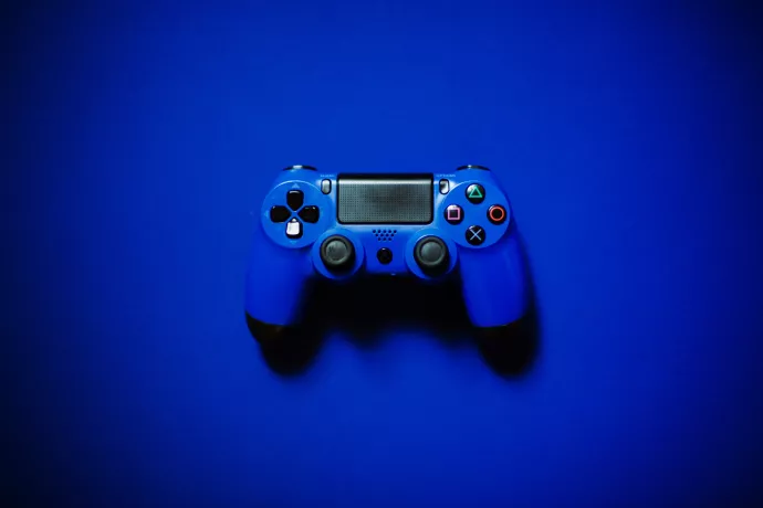 Blue video game controller on blue background