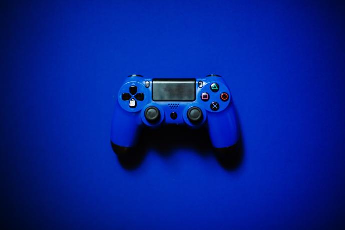 Blue video game controller on blue background