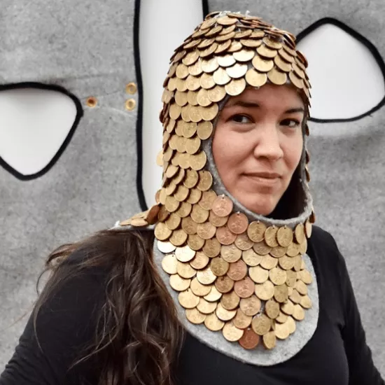 Maria Hupfield wearing a golden headpiece that covers her head and neck
