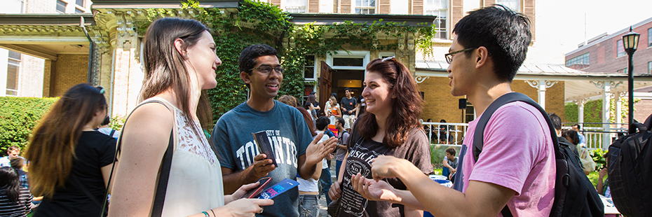 A group of students chatting outside in the summer