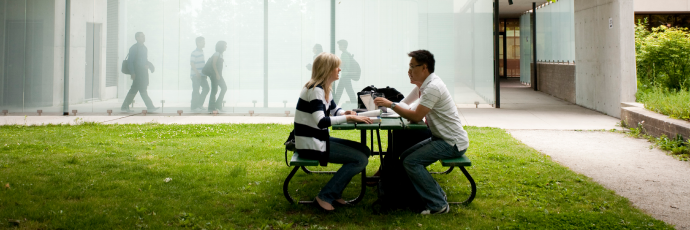 Students chatting on a picnic bench
